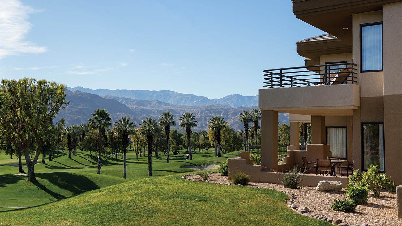 Exterior Marriott's Desert Springs Villas resort timeshare with Harbor date palms, a golf course and mountains the background